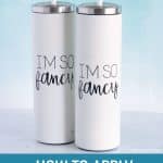 Two white tumblers with viny decals that say 'I'm so fancy'