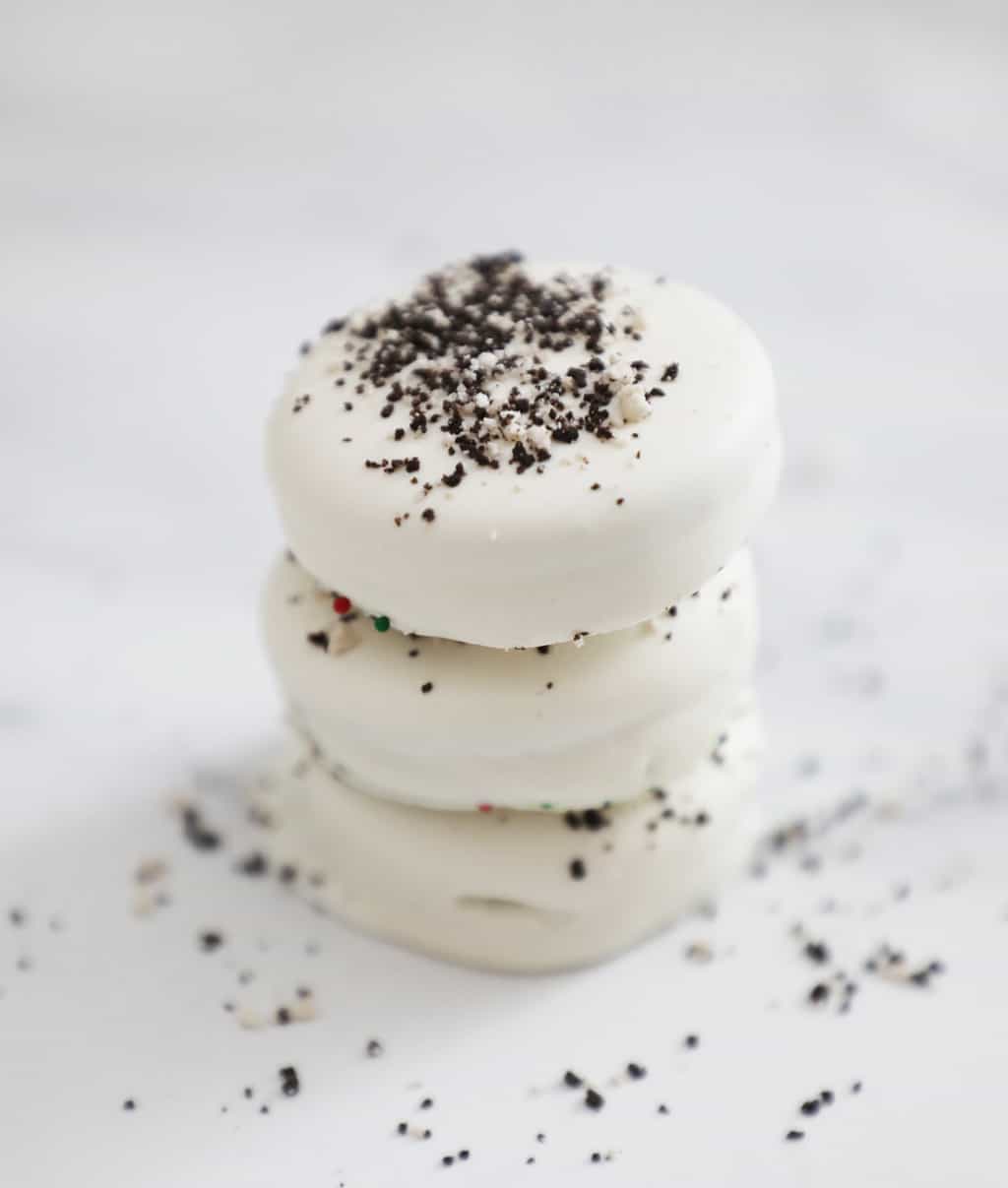 three white fudge covered oreos stacked