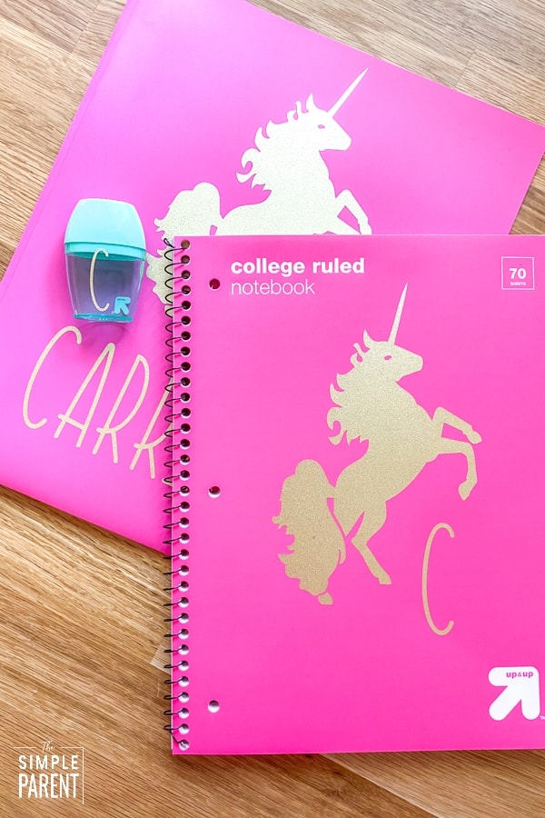 Unicorn gold stickers and initials on pink folders for school