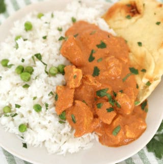 Slow cooker chicken tikka masala in a white bowl with basmati rice