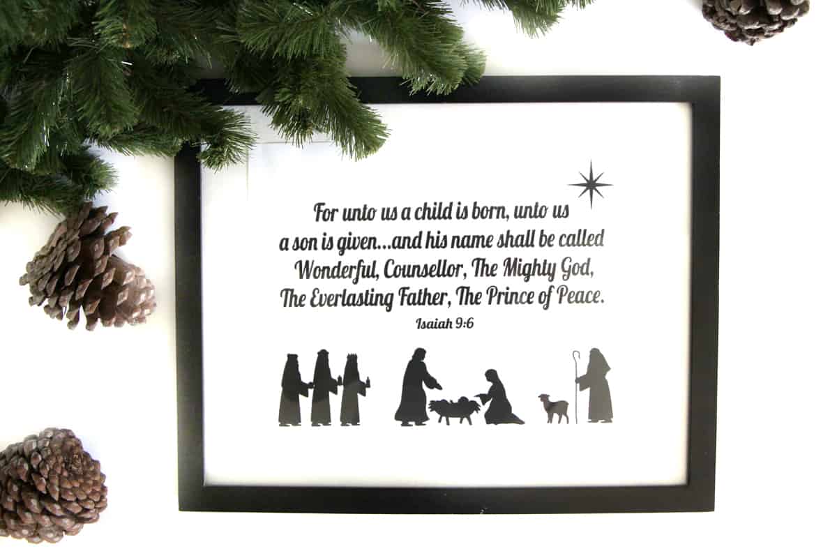 nativity scene in a thin black frame on a white background by a garland