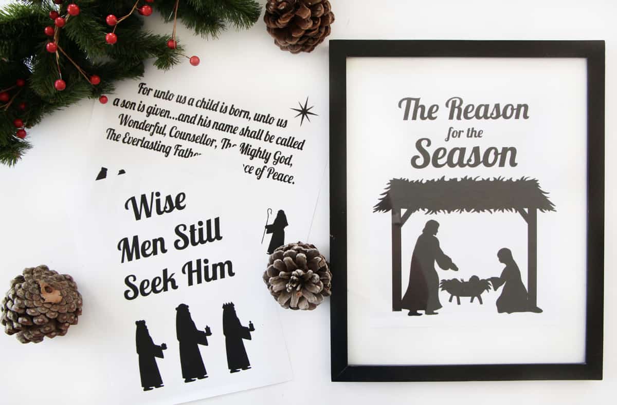 one framed nativity printable and two unframed laying on the table