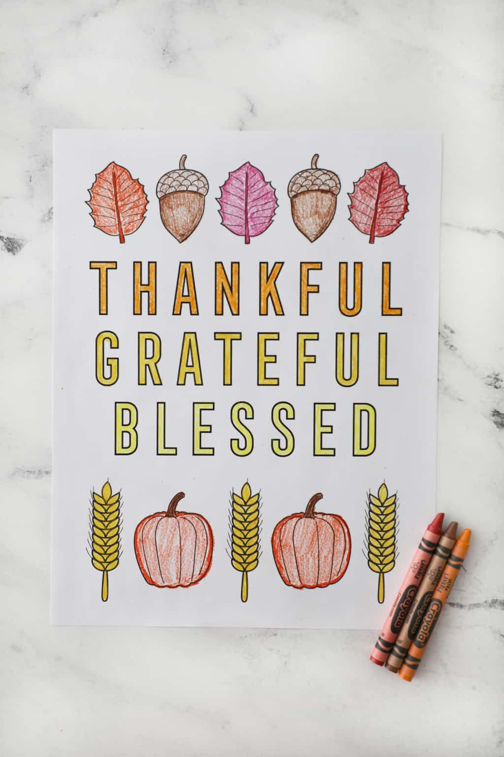 thankful grateful blessed coloring page on a granite countertop with crayons