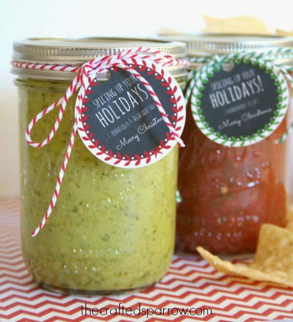 Homemade jars of green and red salsa with Christmas gifts