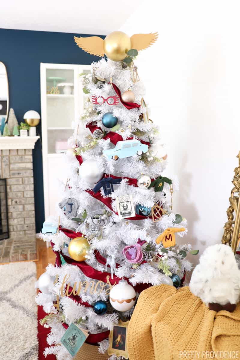 White Christmas tree decorated with Harry Potter Christmas ornaments and golden snitch tree topper