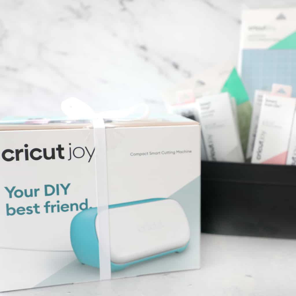 a Cricut Joy in the machine with supplies in the background