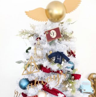 White Christmas tree Harry Potter ornaments and golden snitch tree topper