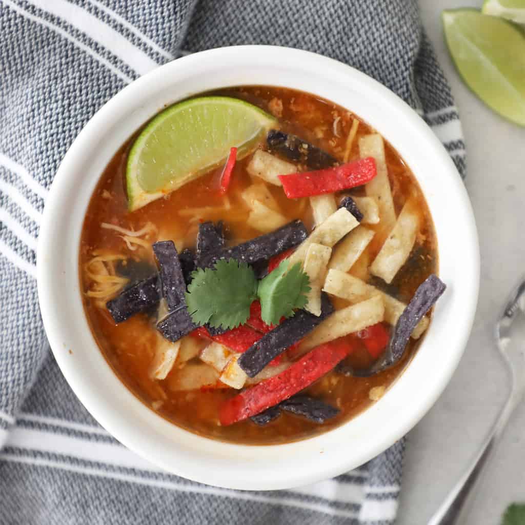 birds eye view of tortilla soup with a lime and tortilla strips