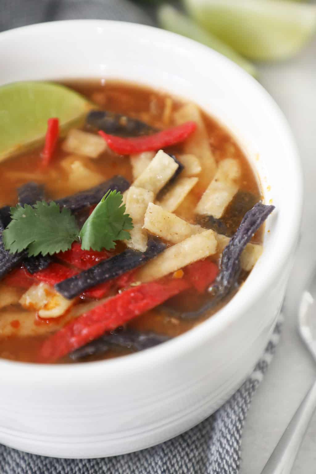 easy tortilla soup in a white bowl garnished with cilantro