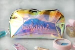 Make up bag that says beautiful in vinyl with kids makeup around it