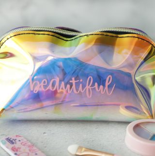 Make up bag that says beautiful in vinyl with kids makeup around it