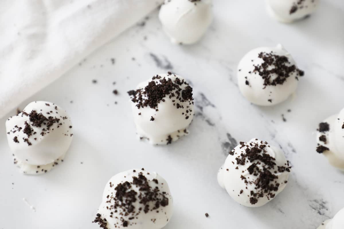 white chocolate dipped Oreo truffles on a granite countertop