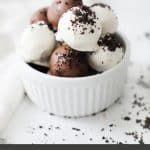 chocolate and white chocolate Oreo truffles in a white bowl optimized for pinterest