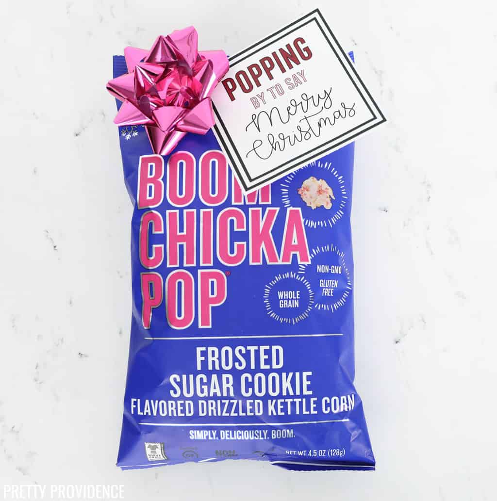 Boom Chicka Pop Sugar Cookie Popcorn with Christmas gift tag and pink bow