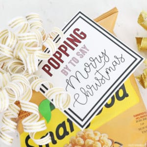 Christmas gift tag on a bag of popcorn that says "Popping by to say Merry Christmas"