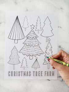 blank Christmas tree coloring page being colored with a green crayon
