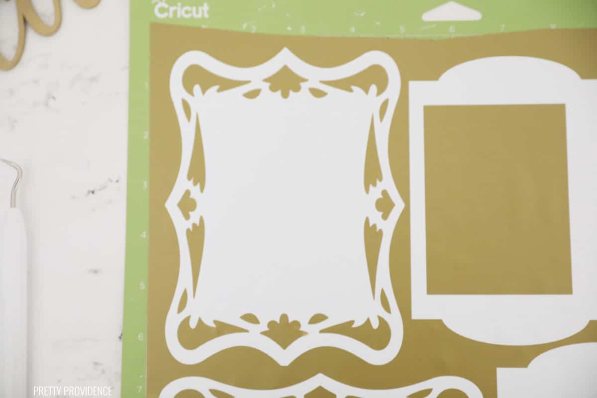 Gold Vinyl with frame embellishments on Cricut green mat