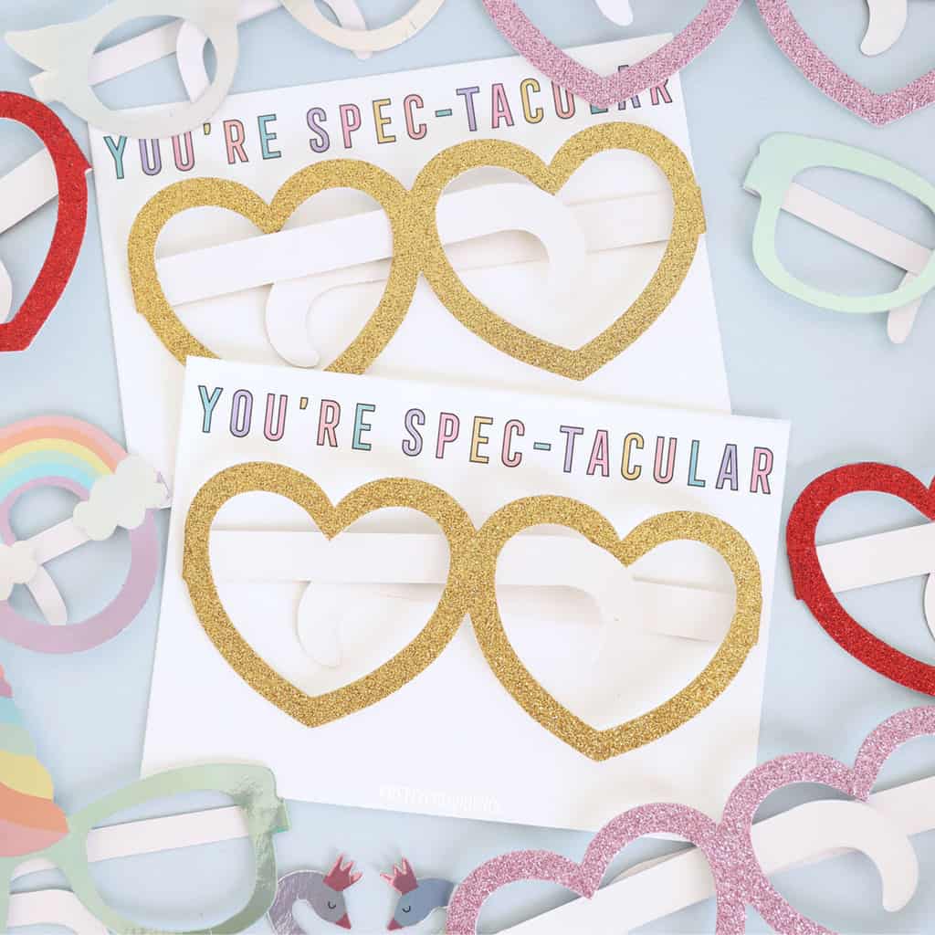 Kids valentines cards printable that say 'you're spectacular' with paper heart glasses taped onto them