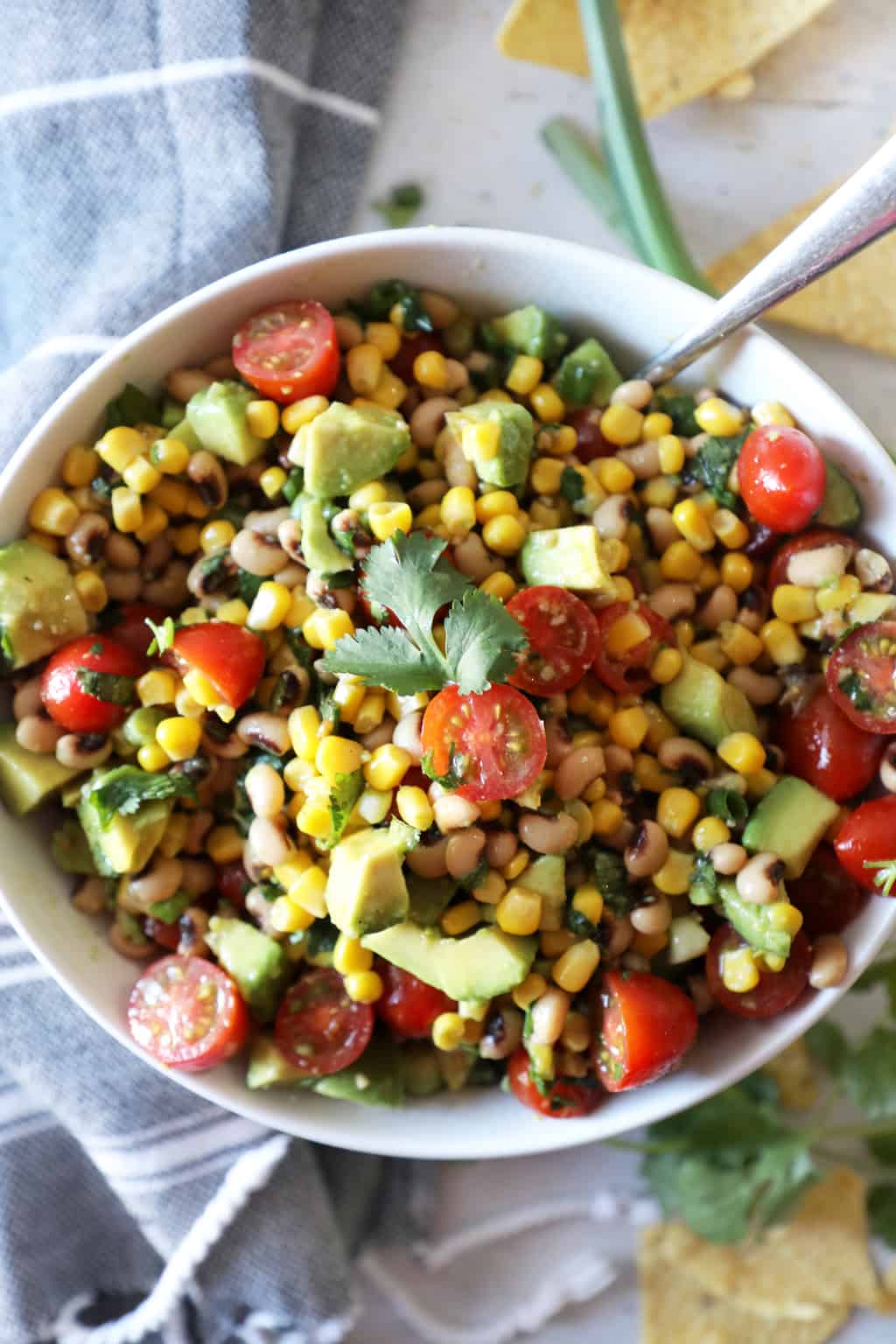 bowl of cowboy caviar surrounded by recipe ingredients