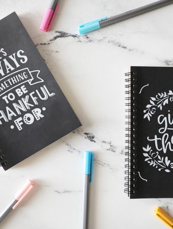kids gratitude journals on marble countertop with colorful pens