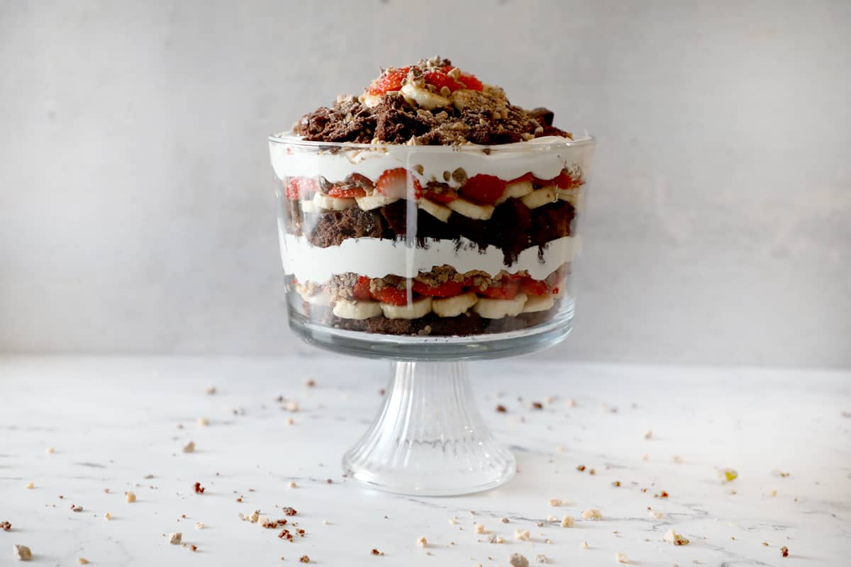 brownie trifle on a white counter against a stone backdrop