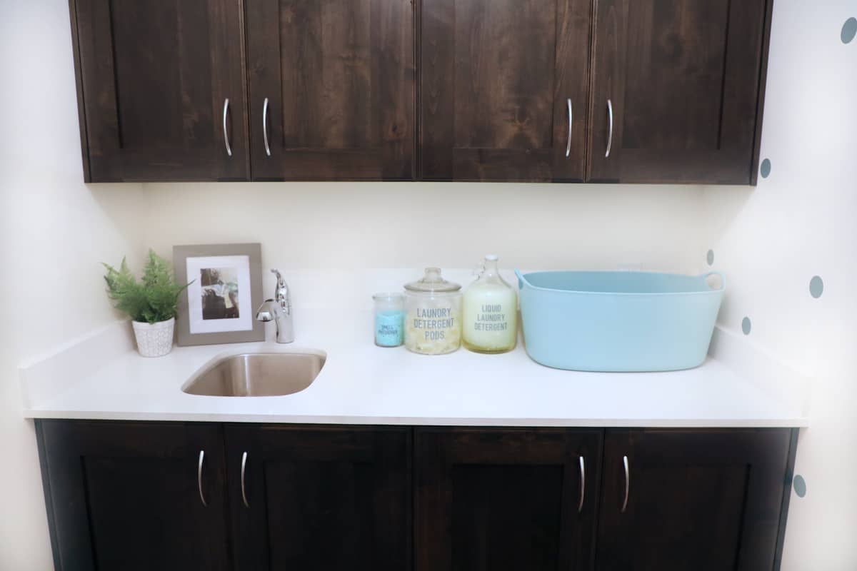 small laundry room white counter with labeled jars