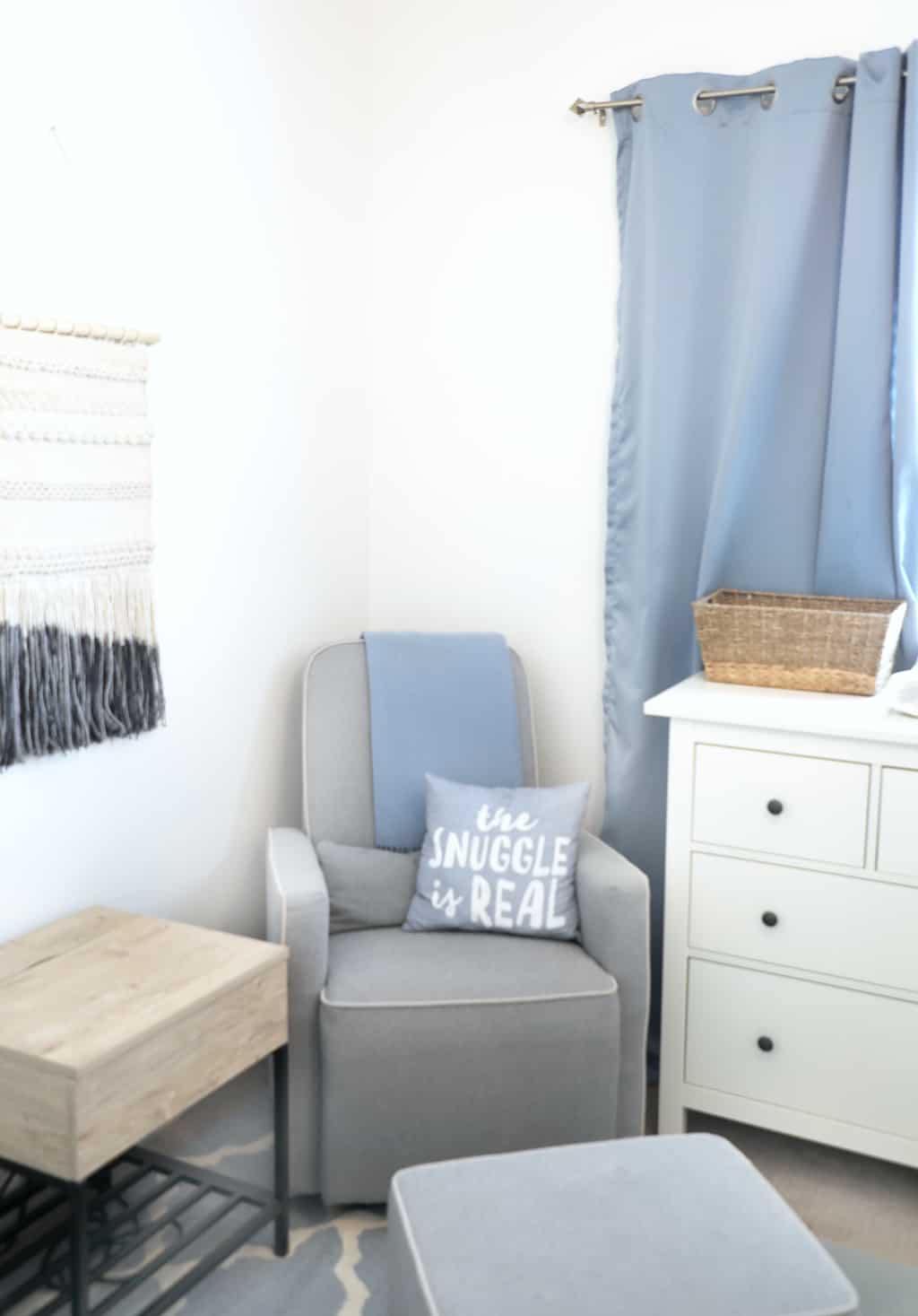 a cozy grey recliner in a corner of a nursery