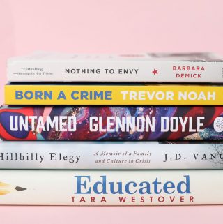 Stack of non-fiction books on a pink background, book club recommendations