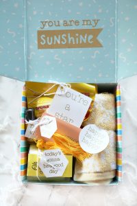 close up image of a "box of sunshine" gift idea on a white countertop