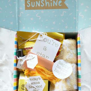 close up image of a "box of sunshine" gift idea on a white countertop