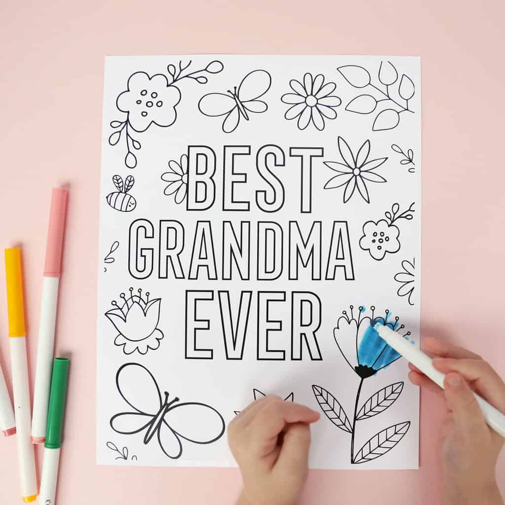 Little hands coloring a floral 'Best Grandma Ever' coloring page