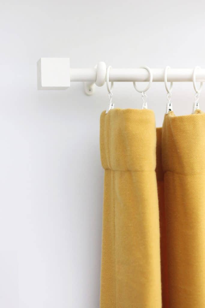 DIY curtain rod and square finial painted white with yellow curtains