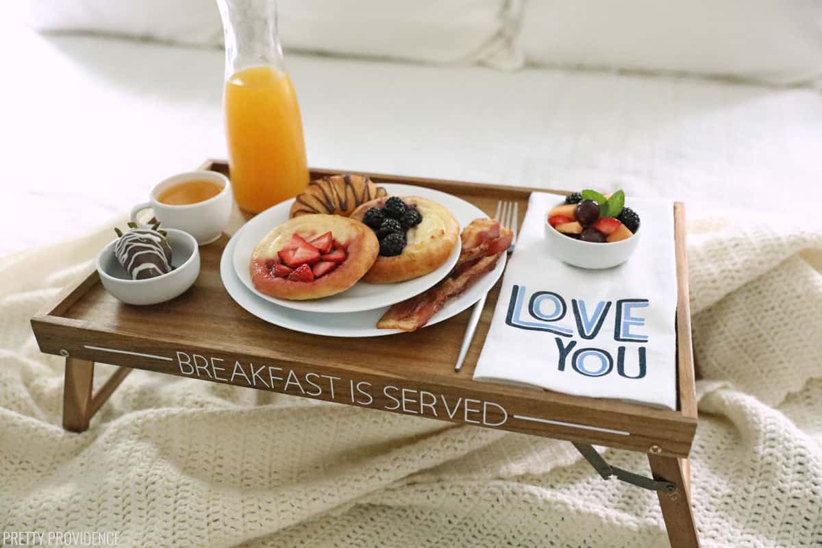 Breakfast in bed tray with food on a bed