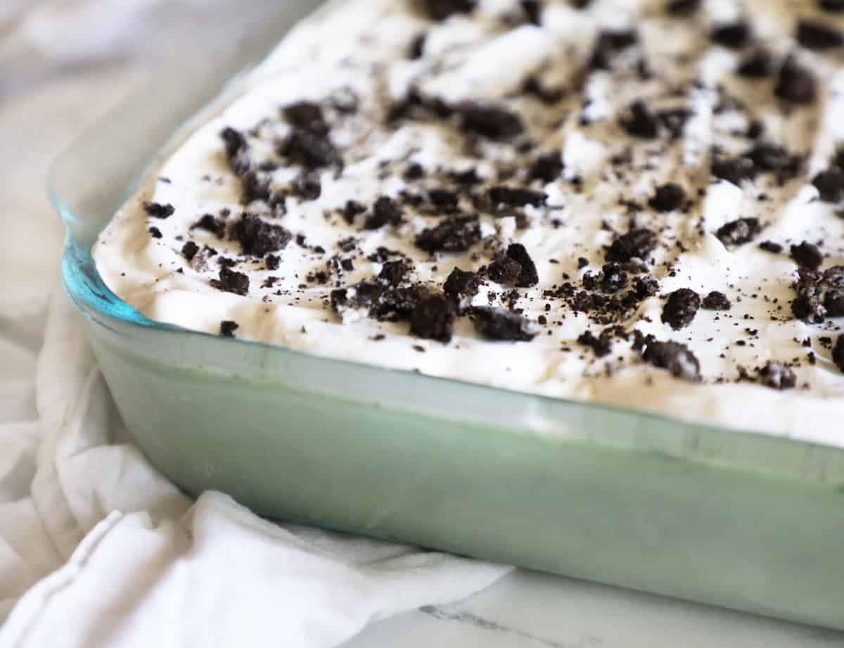 a 9x13 glass pan with mint chocolate chip ice cream cake inside