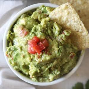 close up of chip in a guacamole bowl