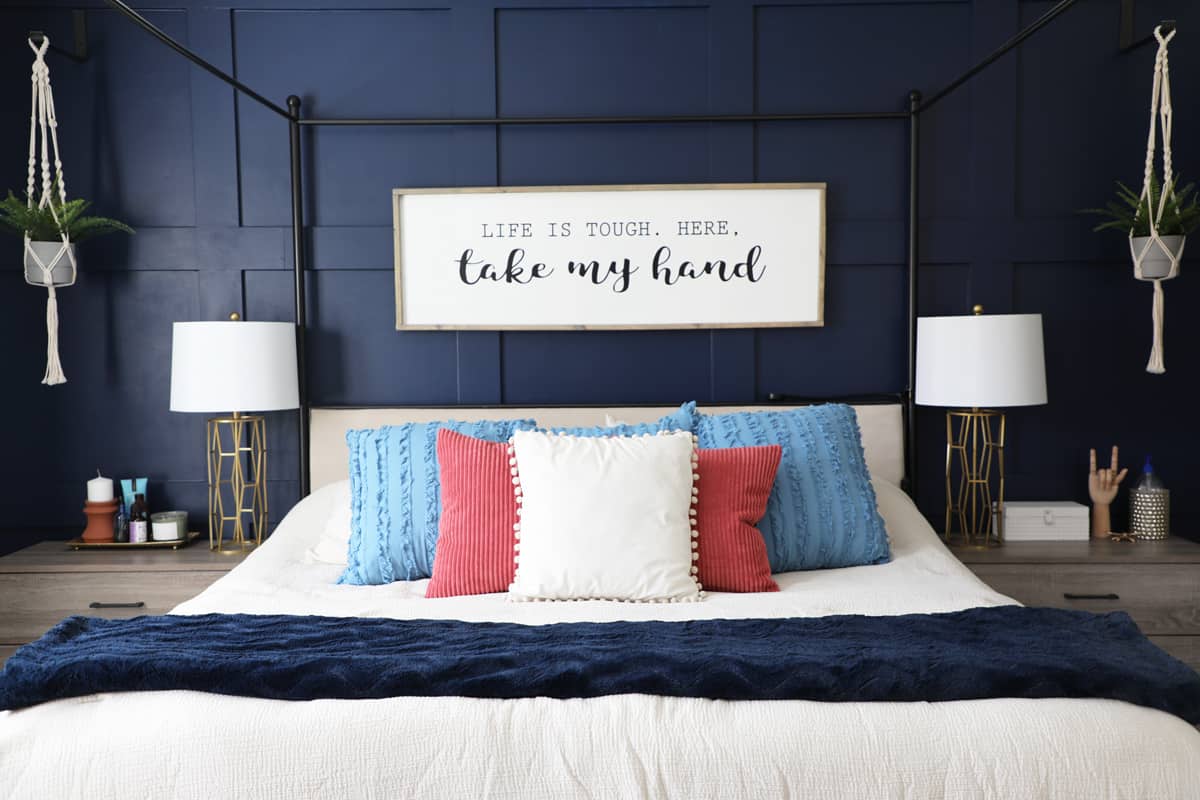 dark blue grid wall behind a king sized bed