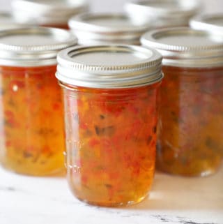 several jars with hot pepper jelly right after being canned