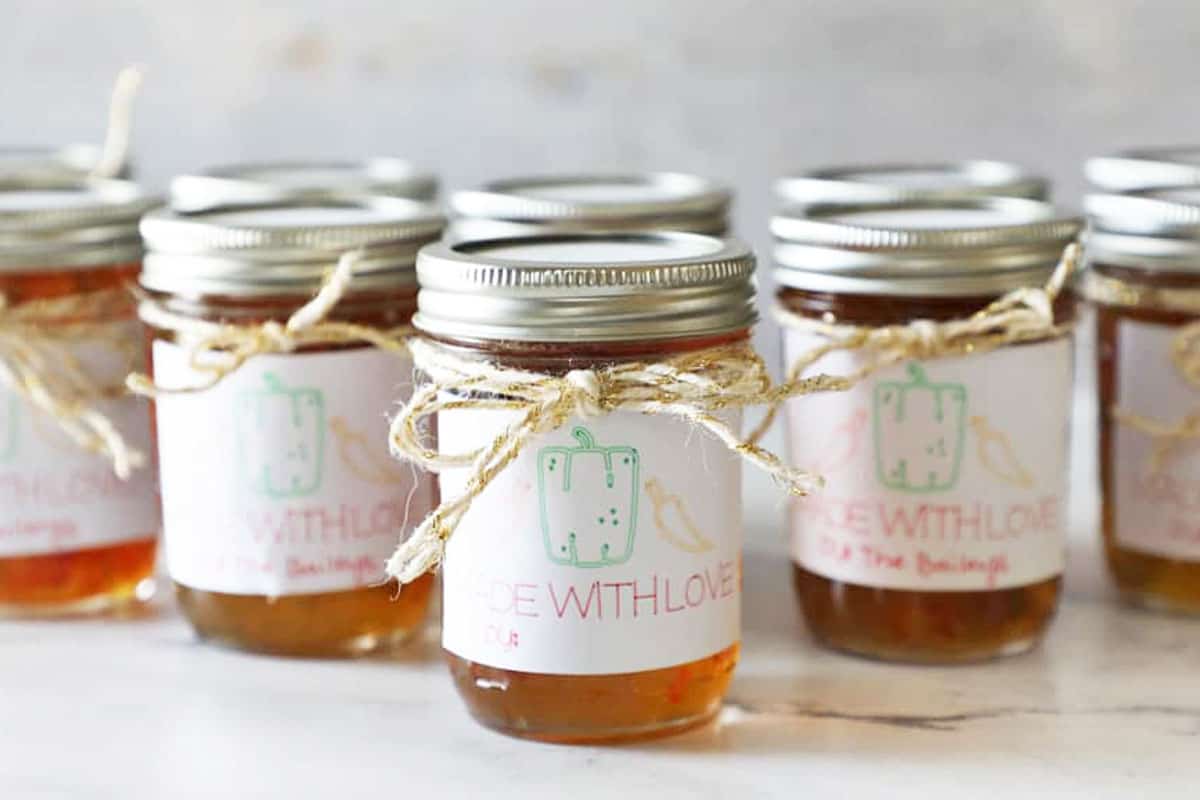 several jars of pepper jelly ready to gift in a triangle shape