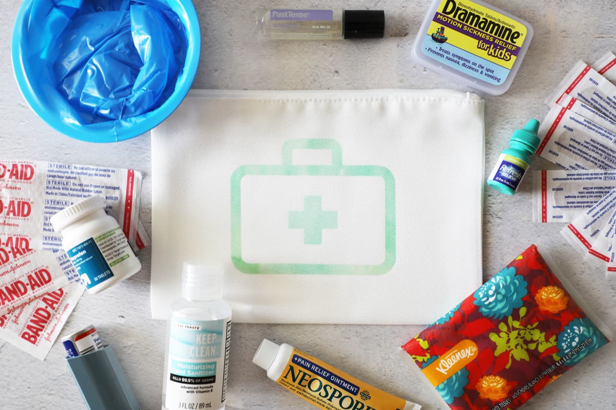 various items that would go in a diy car first aid kit laid out flat