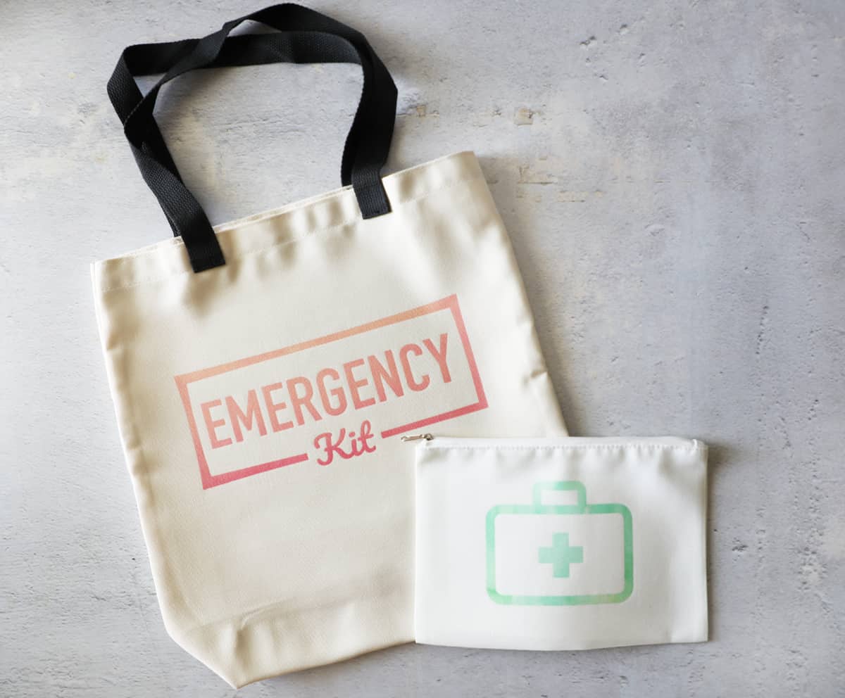 bags for a car emergency kit and car first aid kit next to each other on a concrete surface