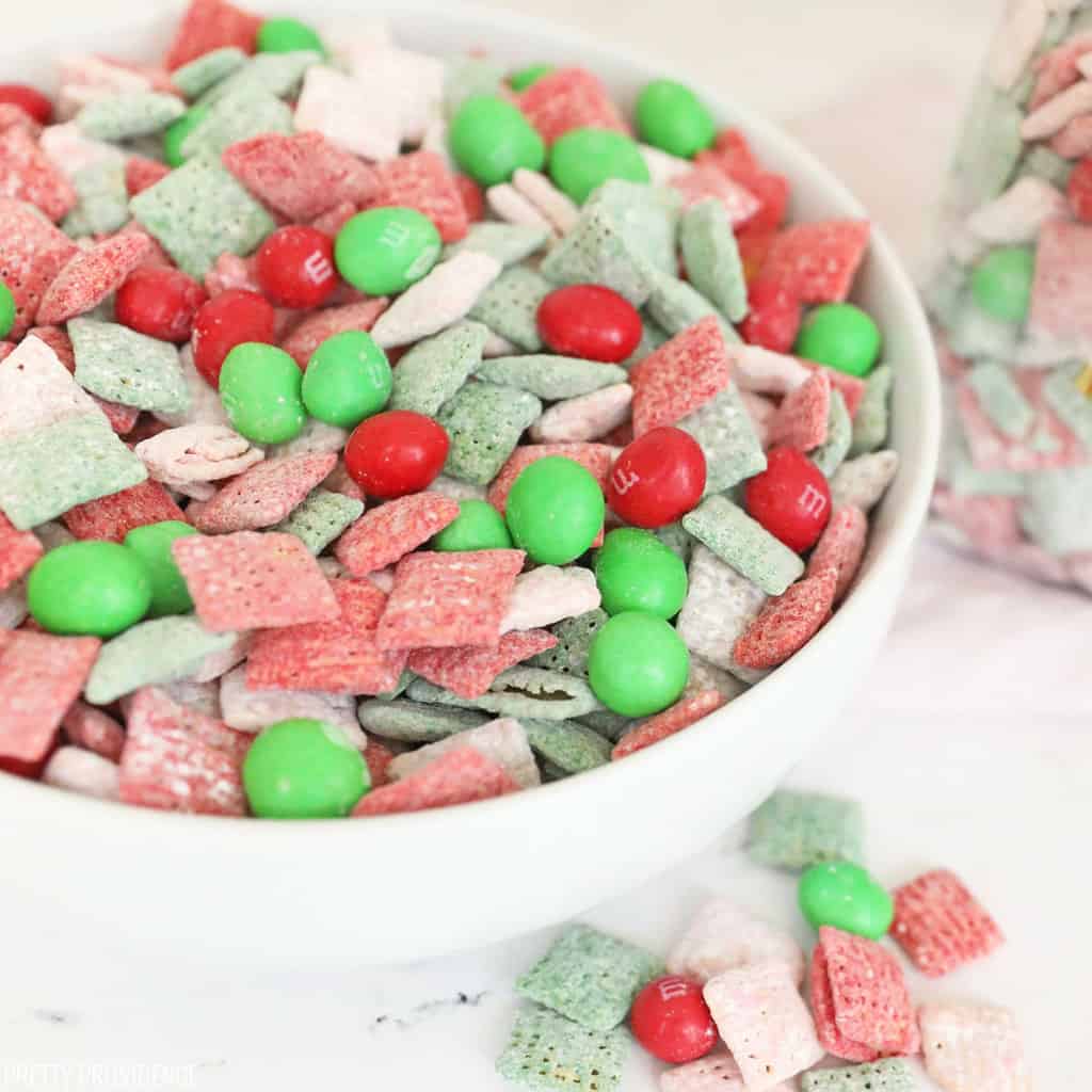 Red, green, pink and white Christmas puppy chow with m&ms in it