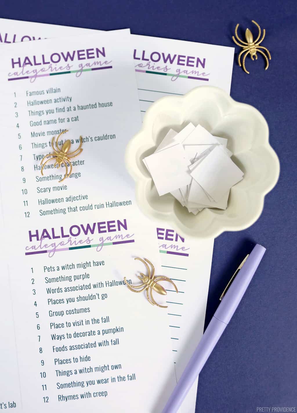 Printed scattergories lists with gold spider toys and a bowl of cut-out paper