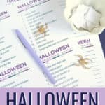 Hallowen categories game printed on white paper, with a purple pen and gold spiders on top of it, on a dark blue surface.