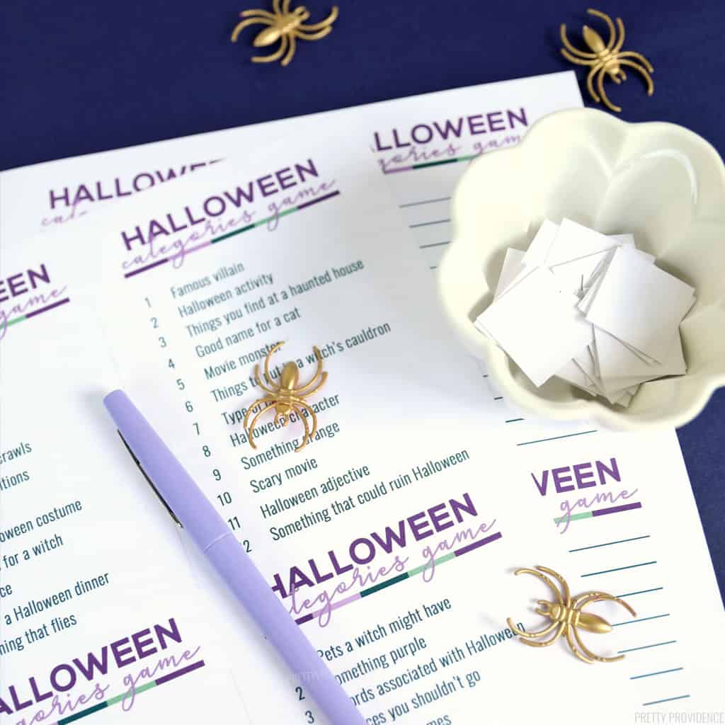 Halloween scattergories game with a purple marker, gold spiders and a bowl with white squares of paper in it