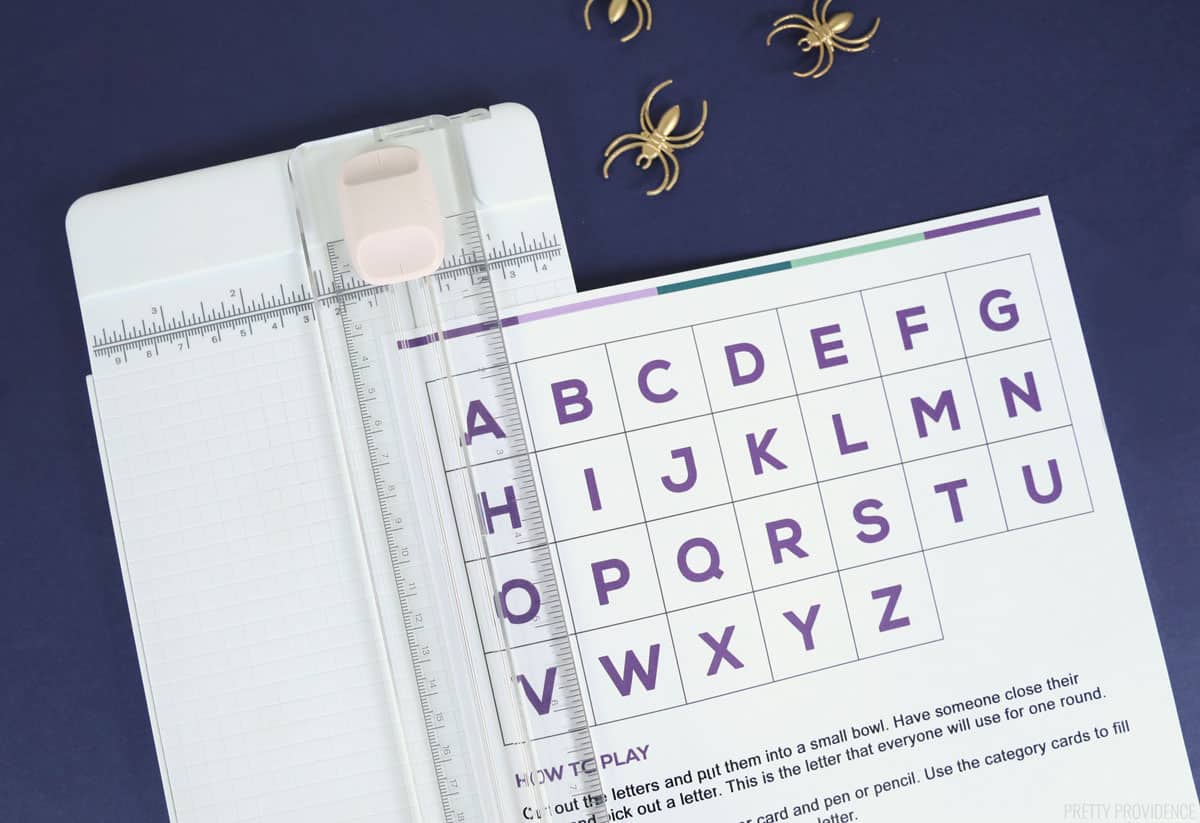 white paper with letters of alphabet in a paper cutter