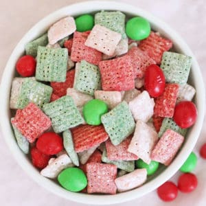 close-up photo of red, green, pink and white chex Muddy Buddies and red and green m&ms mixed together (Reindeer Chow)