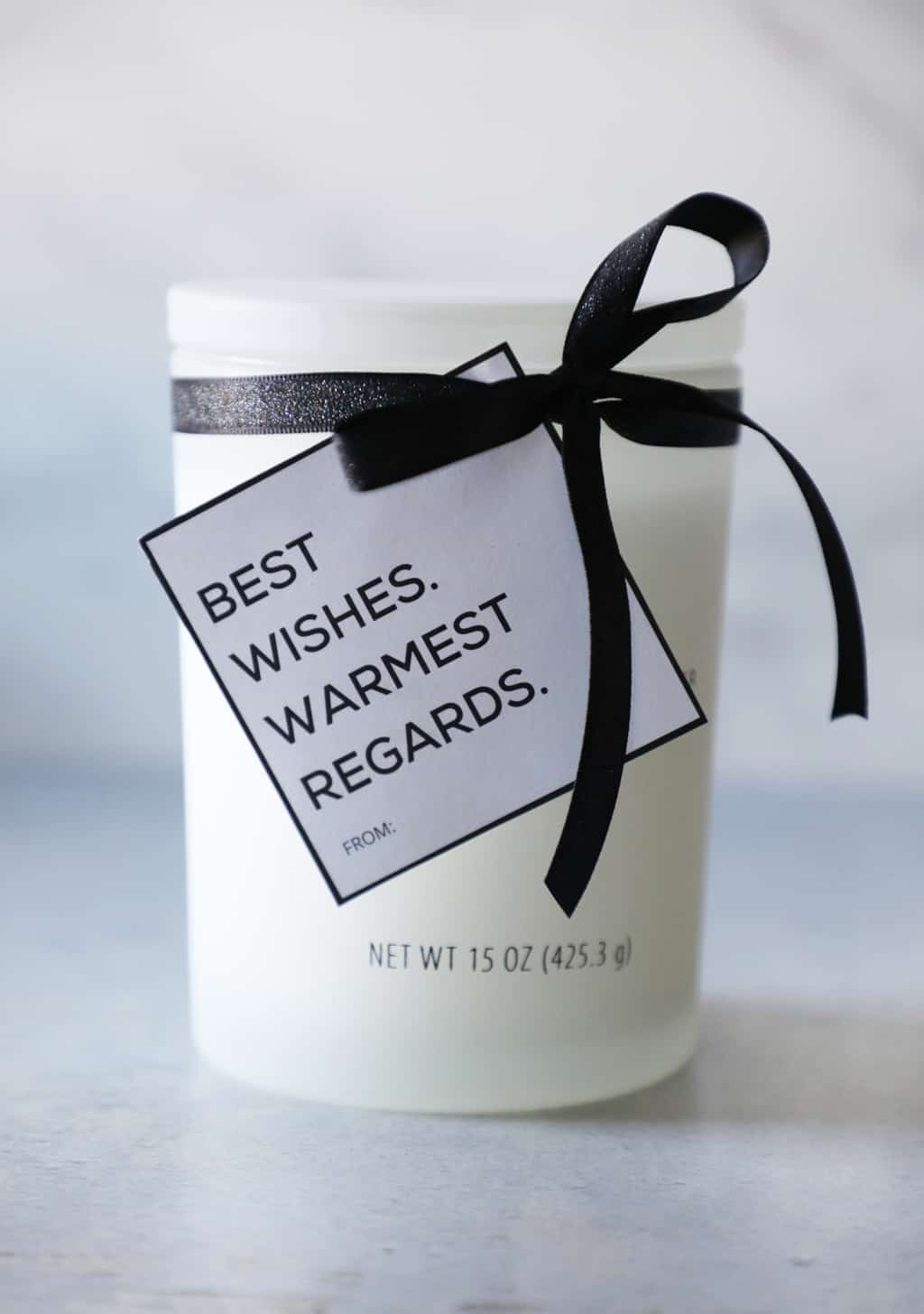 warmest wishes best regards gift tag on a white candle