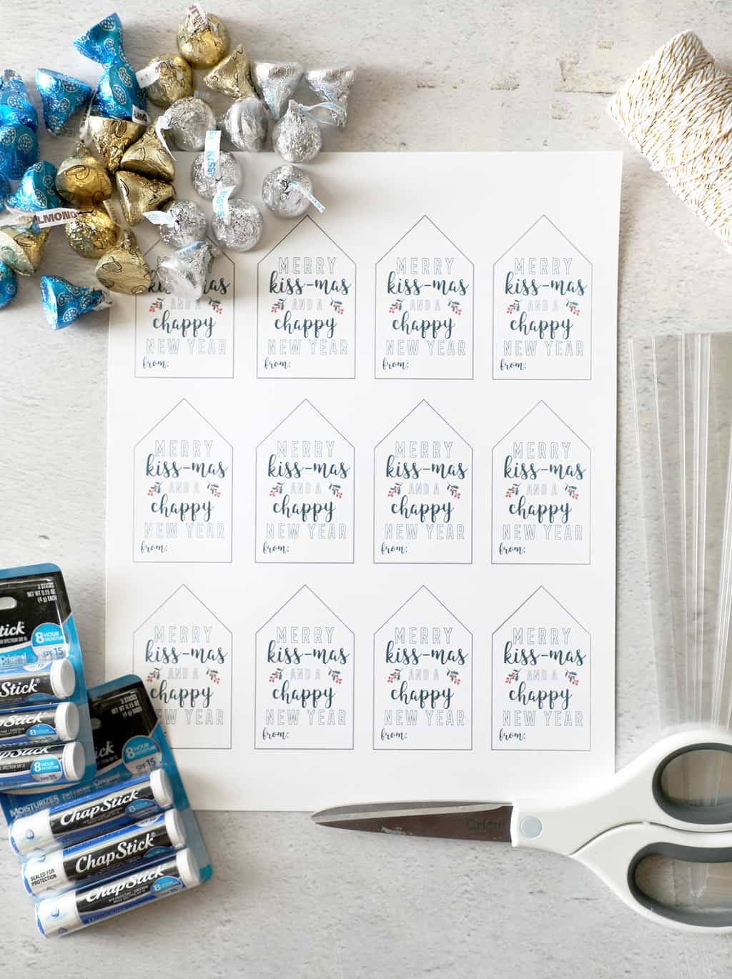 a page of free printable gift tags surrounded by supplies