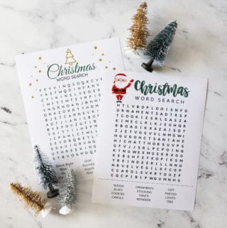 two christmas word searches on a marble countertop by bottlebrush trees