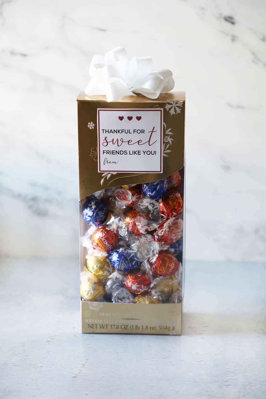 a box of Lindor truffles with a printable tag that says "thankful for sweet friends like you"
